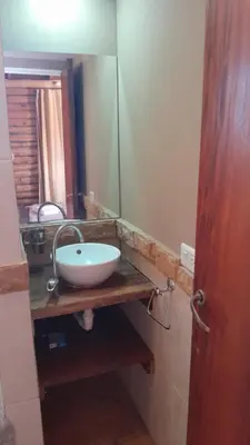 a bathroom with a sink and a mirror at Cabañas de Panaholma in Panaholma