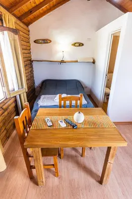 a small room with a table and a bed at Cabañas de Panaholma in Panaholma