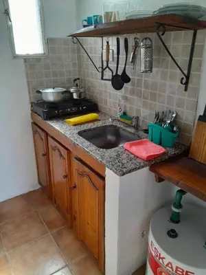 a kitchen counter with a sink and a stove at Cabañas de Panaholma in Panaholma