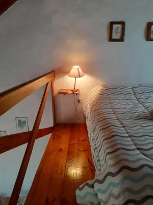 a bedroom with a bed and a lamp on a floor at Cabañas de Panaholma in Panaholma