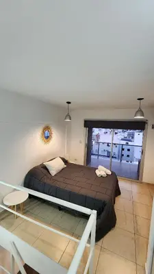 a bedroom with a bed and a large window at Deheza II- Gral Paz-BY Apartments in Cordoba