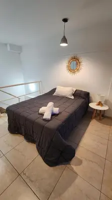 a bedroom with a bed with two towels on it at Deheza II- Gral Paz-BY Apartments in Cordoba