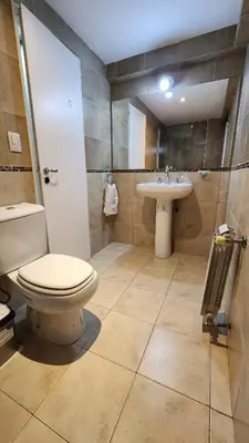 a bathroom with a toilet and a sink at Deheza II- Gral Paz-BY Apartments in Cordoba