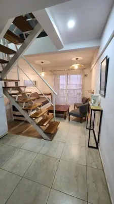 a living room with a staircase in a house at Deheza II- Gral Paz-BY Apartments in Cordoba
