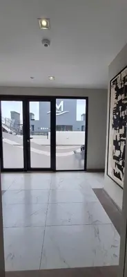 an empty room with doors to an airport runway at Miralejos 17 in Villa Carlos Paz