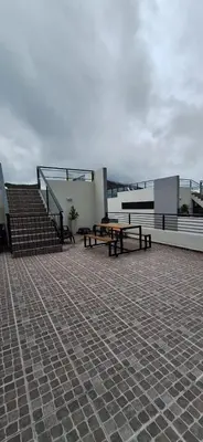 a patio with benches and tables on a building at Miralejos 17 in Villa Carlos Paz