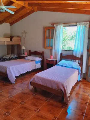 a bedroom with two beds and a window at Casa particular in San Javier