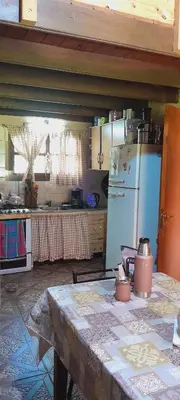 a kitchen with a table and a refrigerator at Casa particular in San Javier