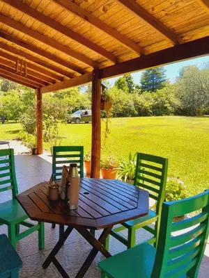 a wooden table and chairs on a patio at Casa particular in San Javier