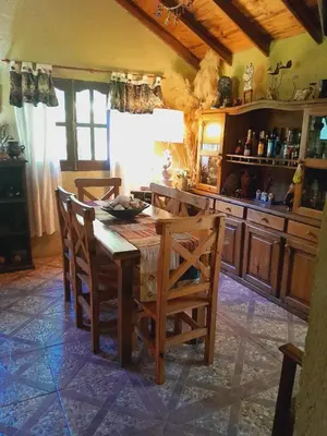 a kitchen with a wooden table and chairs at Casa particular in San Javier