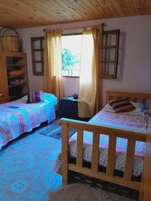 a bedroom with two beds and a window at Casa particular in San Javier