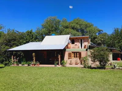 an old brick house with a metal roof at Casa particular in San Javier