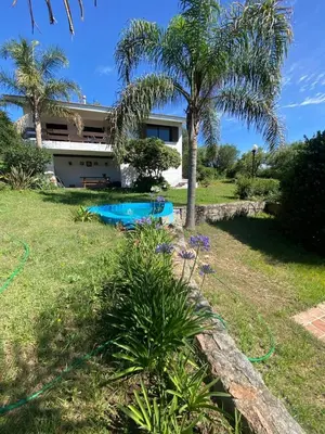 a house with a swimming pool in a yard at Casa Panoramica Maria Ines in Villa Carlos Paz