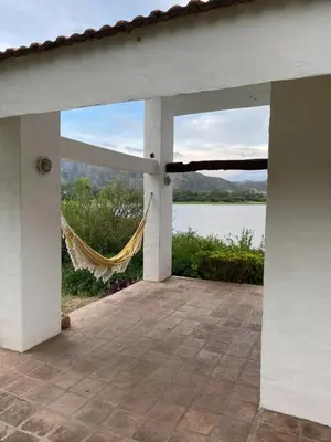 a view from the porch of a house with a hammock at Casa Panoramica Maria Ines in Villa Carlos Paz