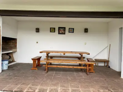 a group of benches sitting in a room at Casa Panoramica Maria Ines in Villa Carlos Paz