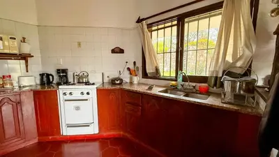 a kitchen with a white stove and a sink at Casa Panoramica Maria Ines in Villa Carlos Paz