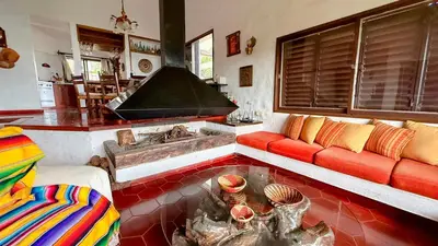 a living room with a couch and a fireplace at Casa Panoramica Maria Ines in Villa Carlos Paz