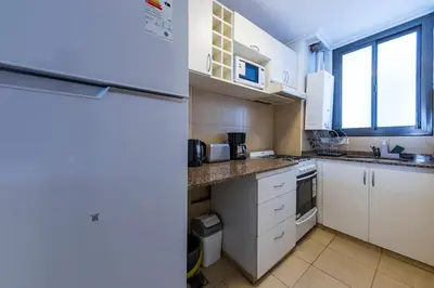 a kitchen with white cabinets and a refrigerator at Lavalleja II in Cordoba