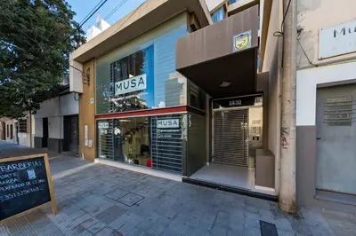 a store front with its doors open on a street at Lavalleja II in Cordoba