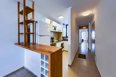 a kitchen with a white refrigerator and a wooden counter at Lavalleja II in Cordoba