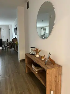 a living room with a table with a mirror at ALOJATE PREMIUM VILLA CARL0S PAZ -Liniers in Villa Carlos Paz