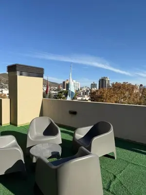 a balcony with chairs and a view of a city at ALOJATE PREMIUM VILLA CARL0S PAZ -Liniers in Villa Carlos Paz