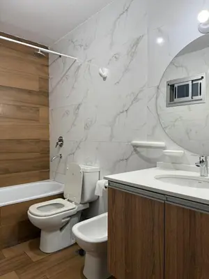 a bathroom with a toilet and a sink and a mirror at ALOJATE PREMIUM VILLA CARL0S PAZ -Liniers in Villa Carlos Paz