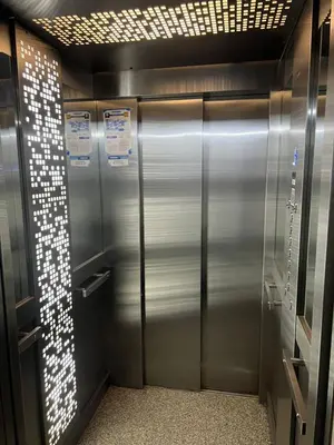 a row of metal elevators in a building at ALOJATE PREMIUM VILLA CARL0S PAZ -Liniers in Villa Carlos Paz