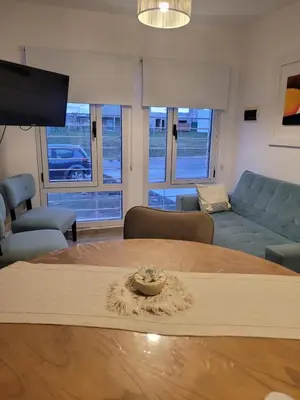 a living room with a table and a couch at Tu Nuevo Hogar in Alta Gracia