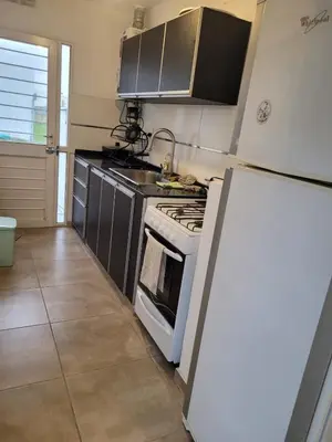 a kitchen with a stove and a refrigerator at Tu Nuevo Hogar in Alta Gracia