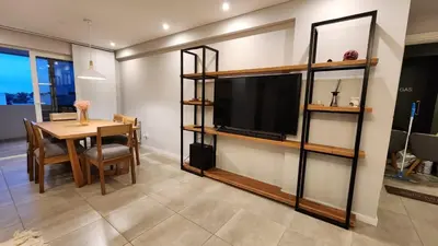 a living room with a tv and a dining room table at Torre GNI Cofico in Cordoba