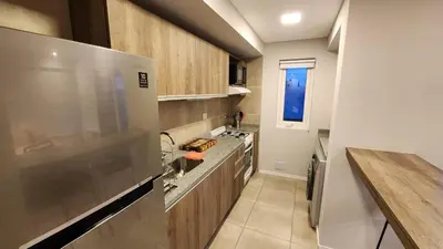 a kitchen with a sink and a stove top oven at Torre GNI Cofico in Cordoba