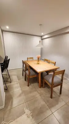 a dining room with a wooden table and chairs at Torre GNI Cofico in Cordoba