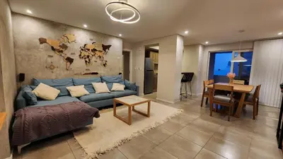 a living room with a blue couch and a table at Torre GNI Cofico in Cordoba