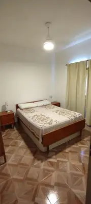 a bedroom with a large bed in a room at Pan de Azúcar 3 dias mínimo de alojamiento in Villa Parque Siquiman