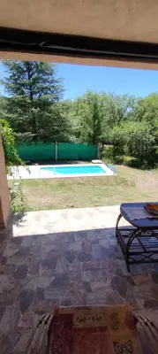 a view of a swimming pool through a window at Pan de Azúcar 3 dias mínimo de alojamiento in Villa Parque Siquiman