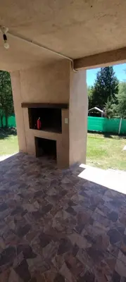 a living room with a stone floor and a fireplace at Pan de Azúcar 3 dias mínimo de alojamiento in Villa Parque Siquiman