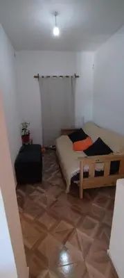 a bedroom with a bed and a suitcase on the floor at Pan de Azúcar 3 dias mínimo de alojamiento in Villa Parque Siquiman