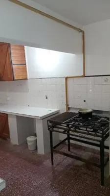 a kitchen with a stove and a table in it at CASONA Malva del Rio in Villa Carlos Paz