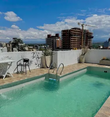 a swimming pool on the roof of a building at Hotel Toulon in Villa Carlos Paz