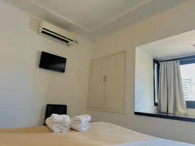 a bedroom with a bed with two towels at Hotel Toulon in Villa Carlos Paz