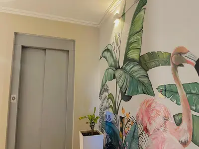 a room with a painting of a flamingo on the wall at Hotel Toulon in Villa Carlos Paz