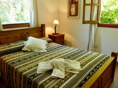 a bedroom with two beds with towels on them at departamentos pama in Santa Rosa de Calamuchita