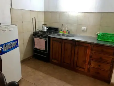 a kitchen with a stove and a sink at departamentos pama in Santa Rosa de Calamuchita