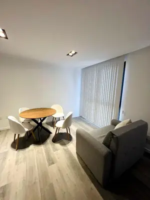 a living room with a couch and a table and chairs at Miralejos 17 in Villa Carlos Paz