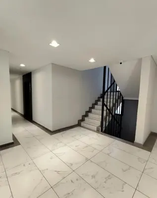 an empty room with a staircase and a tiled floor at Miralejos 17 in Villa Carlos Paz