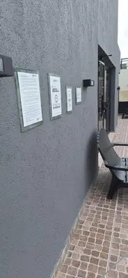 a bench sitting next to a wall with signs on it at Miralejos 17 in Villa Carlos Paz
