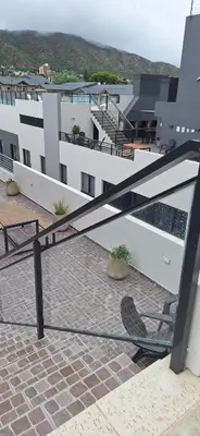 a balcony with a chair on top of a building at Miralejos 17 in Villa Carlos Paz
