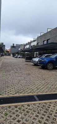 a parking lot with cars parked in front of buildings at Miralejos 17 in Villa Carlos Paz