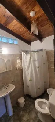a bathroom with a toilet and a sink at Cabaña Hakuna matata in Santa Rosa de Calamuchita